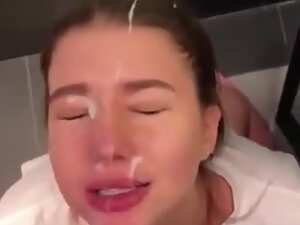 Slutty girl rubs cum all over her face