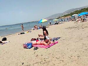 Hot pale girl suntanning on her first beach day Picture 1