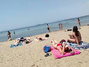 Hot pale girl suntanning on her first beach day Picture 2