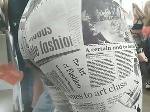 Reading the newspaper on hot ass