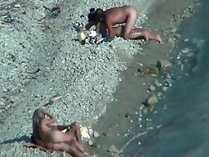 Two couples enjoying sex on a beach