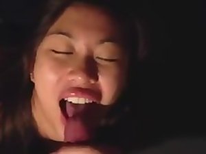 Happy asian girl gets cum on her tongue