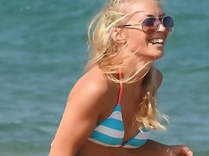 Fit blonde plays on beach