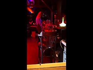 Big boobs of a very slutty waitress at a bar