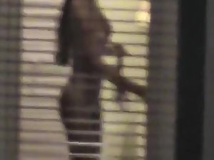 Naked girl peeped through a window