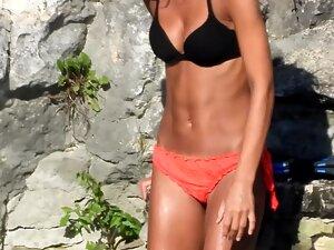 Fit tanned girl looks like a model in the water Picture 7