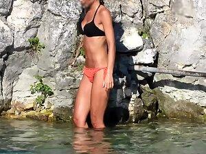 Fit tanned girl looks like a model in the water