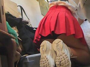 Upskirt of store clerk while she kneels down
