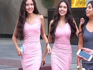 Beautiful twin sisters in matching pink dresses